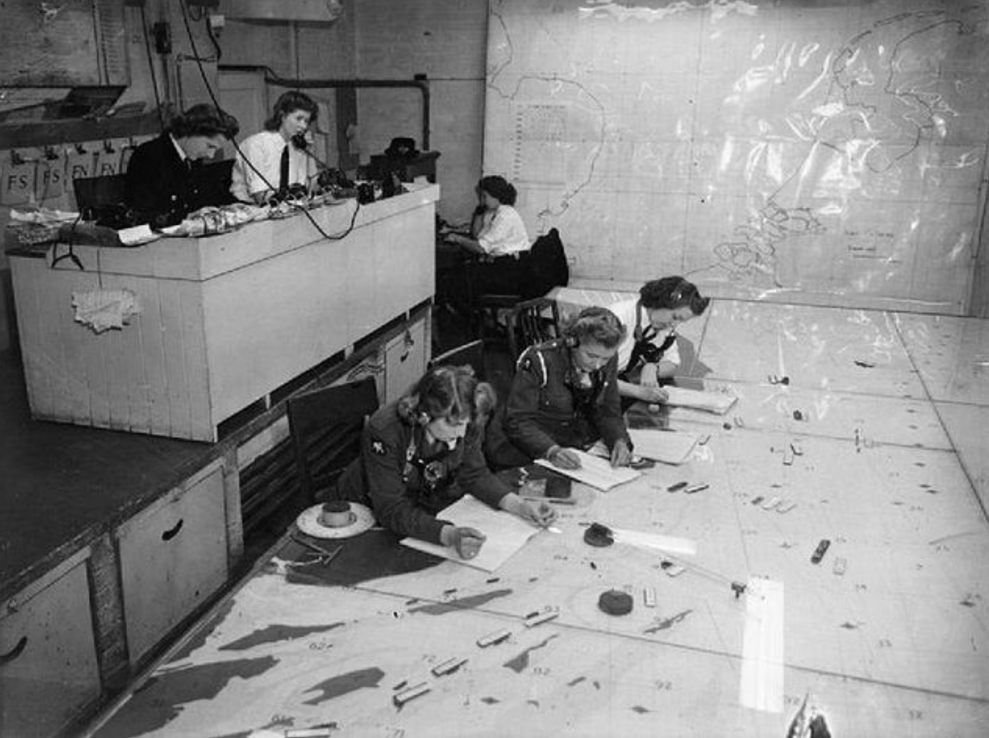 Women's Royal Naval Service officers in the plotting room at Hamilton House, Headquarters of the Flag Officer. 